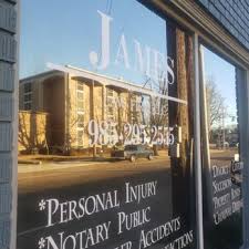 James & Bradley Law Firm window with reflection