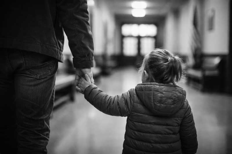 little girl escorted to her child custody case